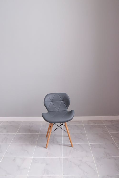 Gray Chair with Wooden Legs on Gray Floor Tiles