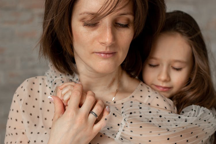 Daughter Hugging Mother From Behind