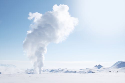 Free Smoke Rising from Snow-covered Field Stock Photo