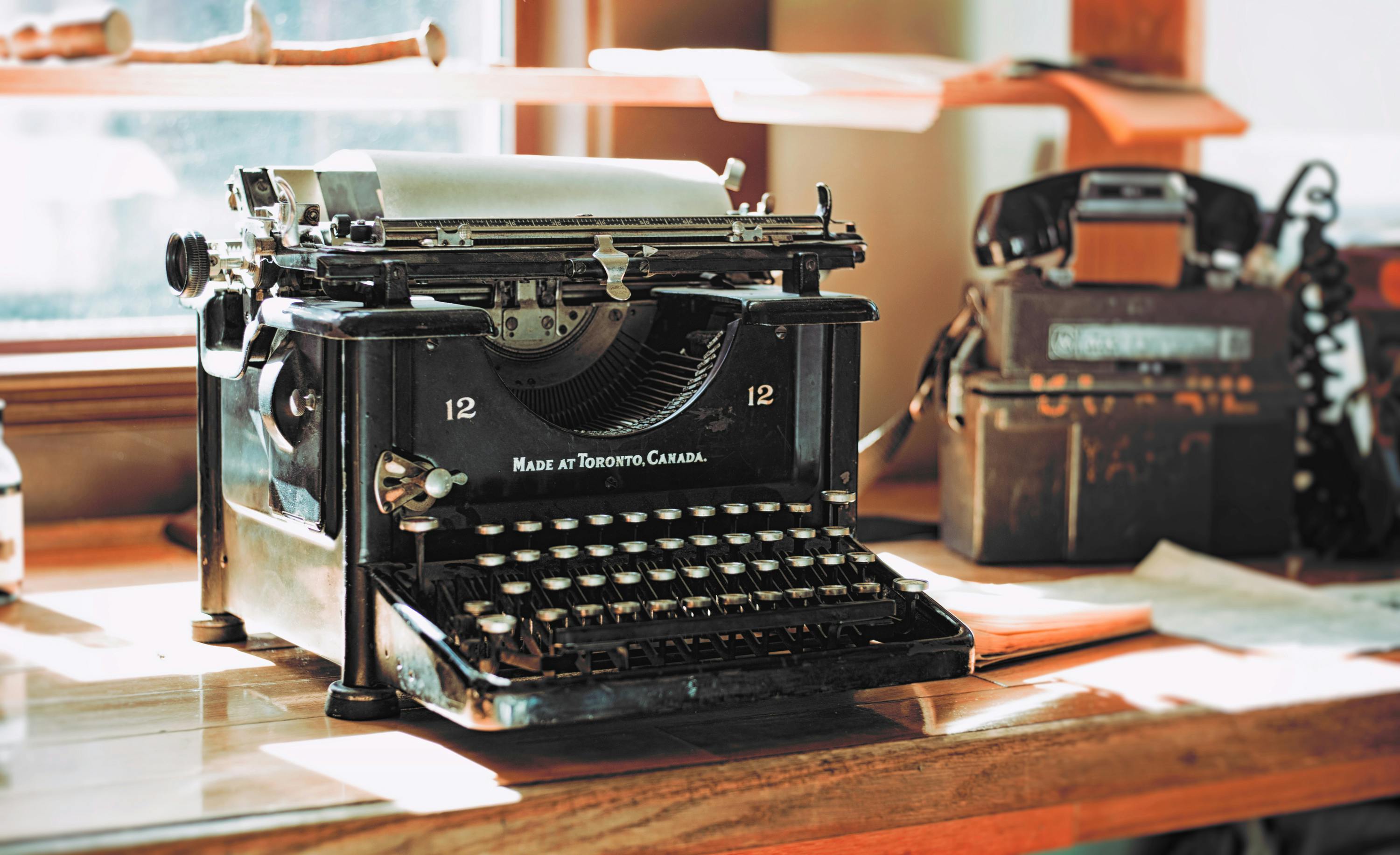 Classic Black Typewriter On Brown Wooden Desk Free Stock Photo