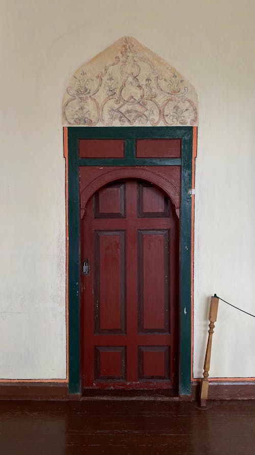 Red Wooden Door on White Wall