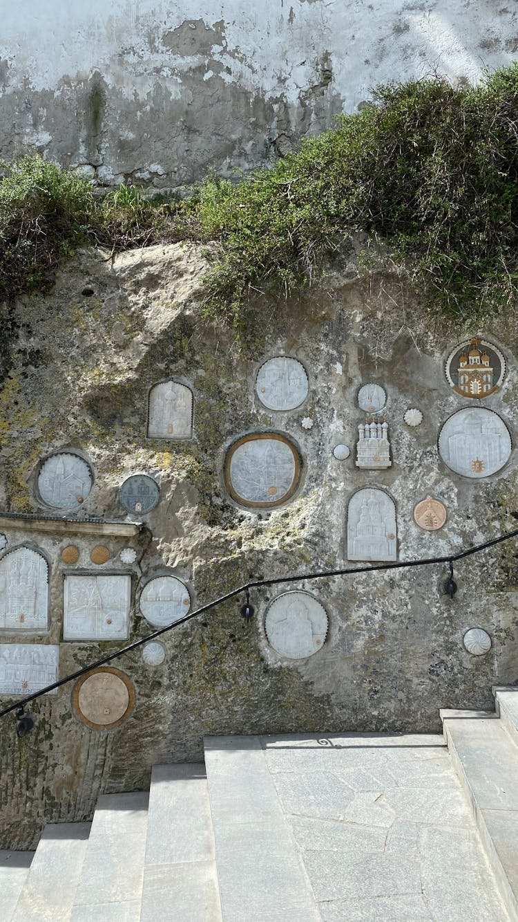 Rock Wall Beside The Concrete Stairs With Murals