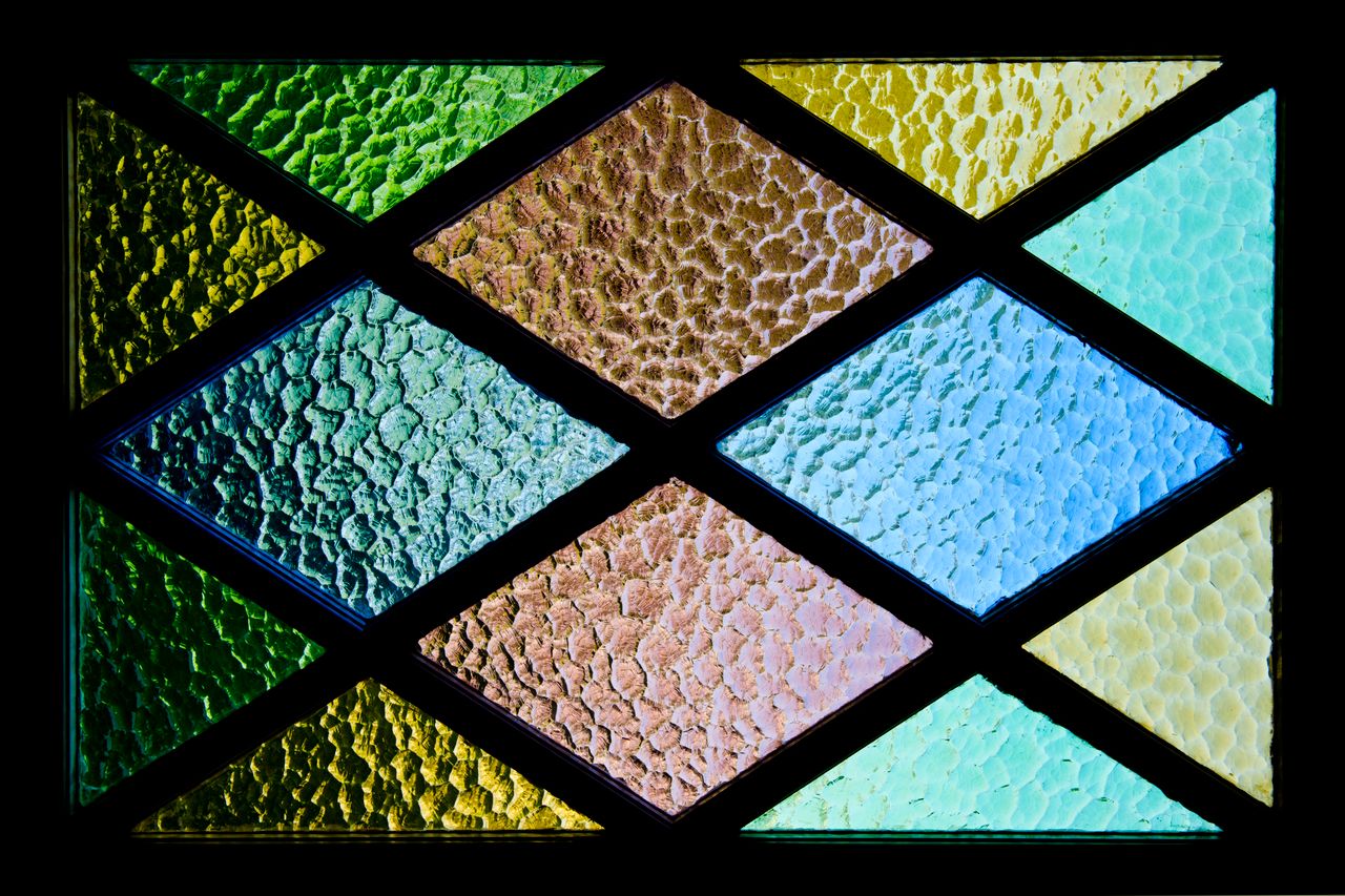 vibrant stained glass featuring textured geometric patterns and colorf