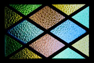 Leaded glass panes in green and amber — photo by Tim Mossholder on Pexels