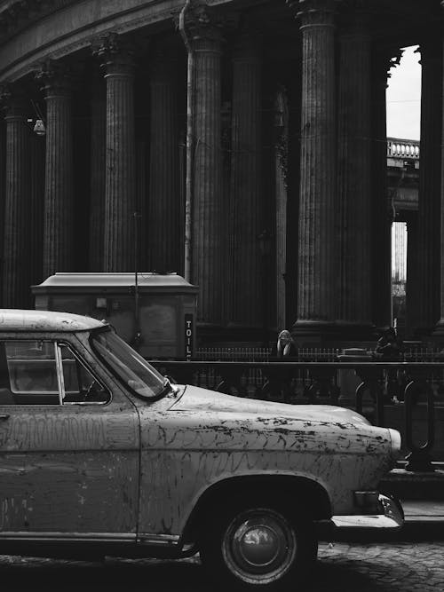 Grayscale Photo of an Old Car on Road