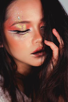 Close-up of a woman with glitter makeup, showcasing artistic and glamorous style.