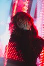Woman in Black Jacket Surrounded with Red Lights