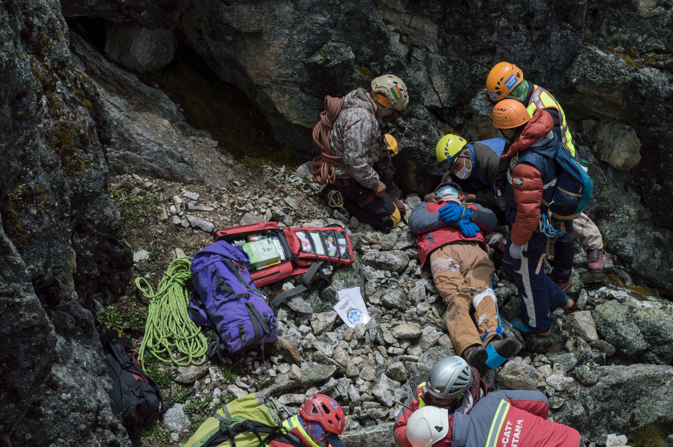 rescue team saving an injured person on rocky mountainside