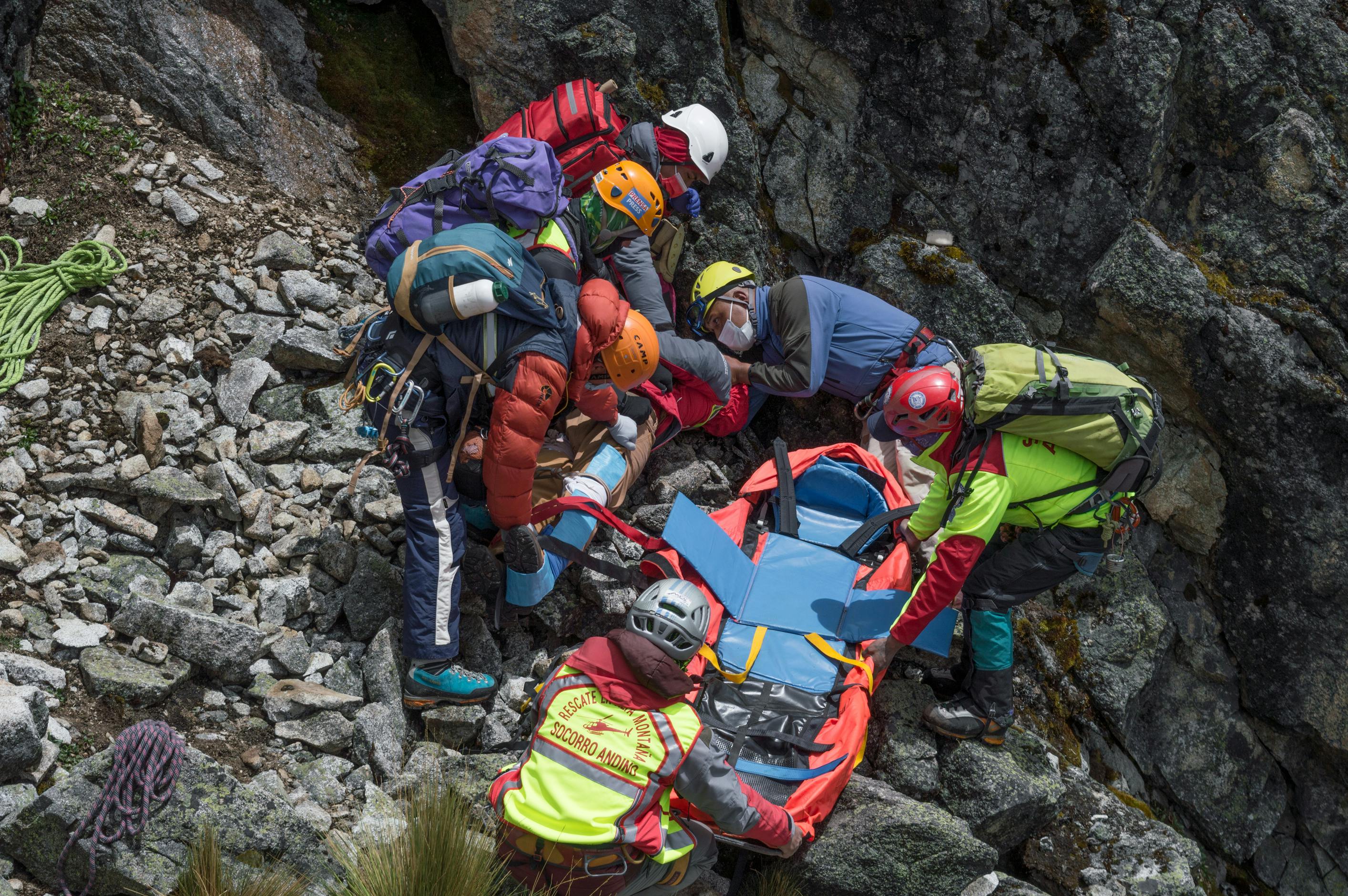 group of men with helmets holding stretcher