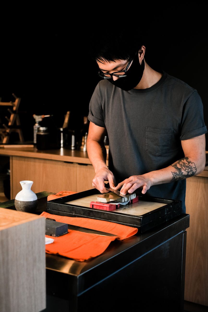 Kitchen knife being sharpened on a whetstone