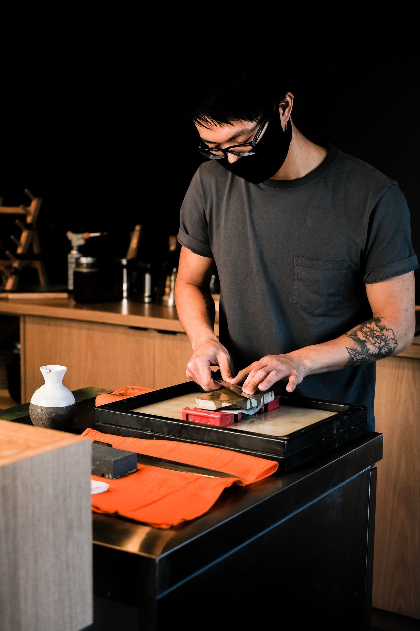 A blade being sharpened on a whetstone