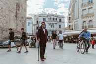 Lively urban scene with people walking and cycling in Tunis, Tunisia.