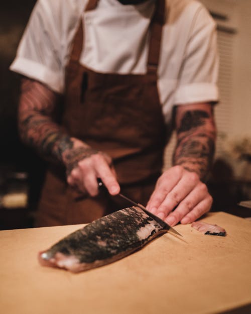 Person Slicing Black Meat