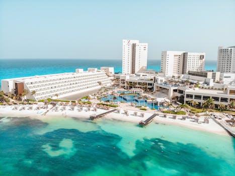 Stunning aerial view of Cancun beach resort, showcasing blue waters and sunny skies, ideal for a summer vacation.