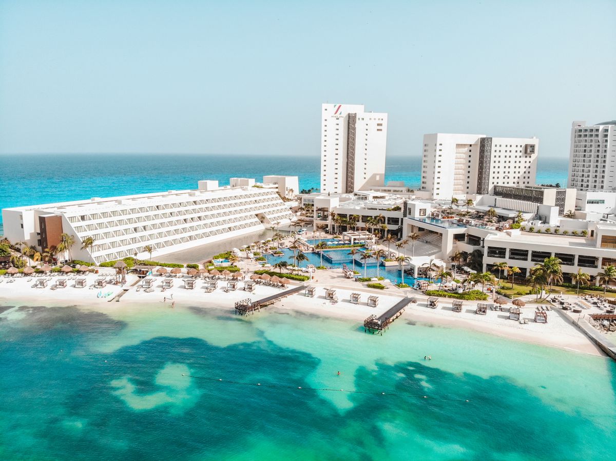 Stunning aerial view of Cancun beach resort, showcasing blue waters and sunny sk