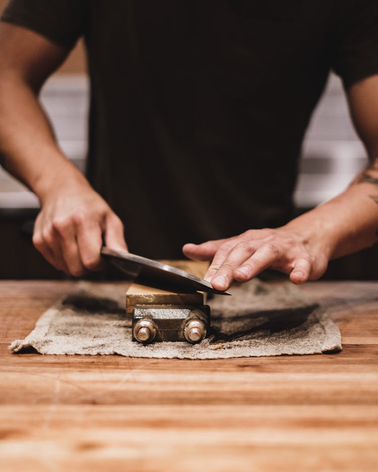 Man Sharpening A Knife