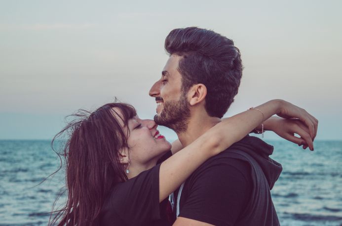 latina couple enjoying first date at outdoor cafe