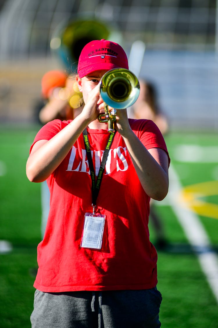 Person In Red Shirt Playing The Trumpet