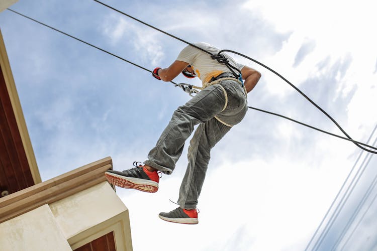 Man Wearing Harness Going Down Building