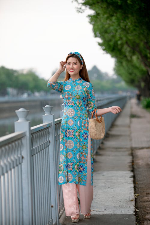 Free Beautiful Woman Standing Beside a Railing Stock Photo