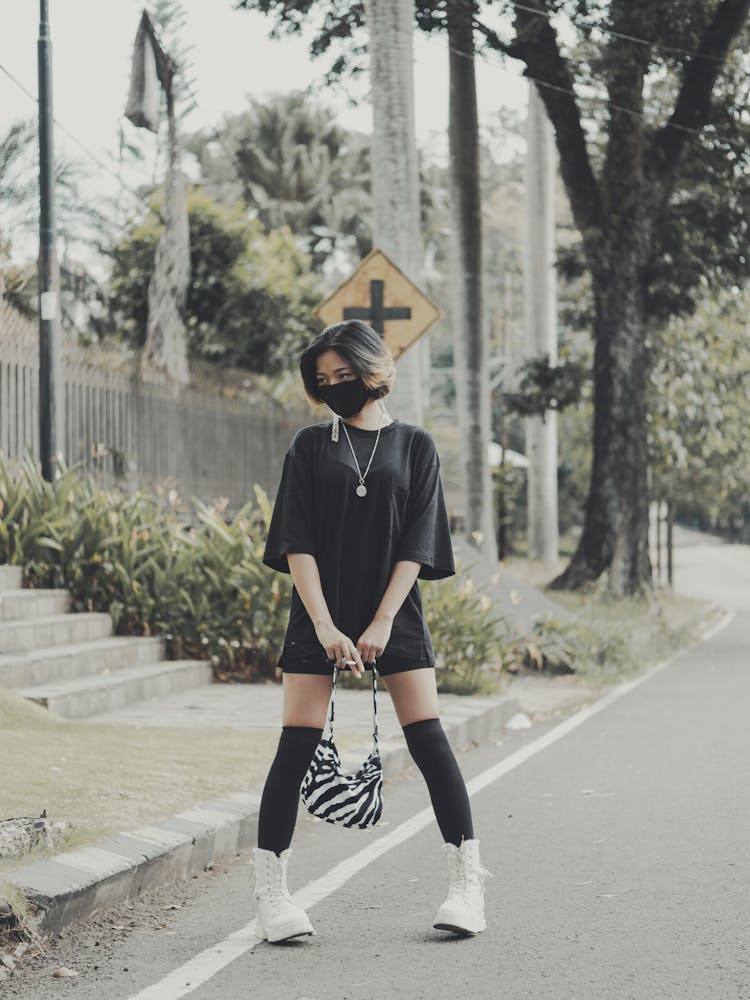 Woman In Streetwear With Black Face Mask