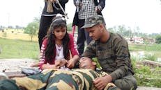 Woman in Green and Brown Camouflage Uniform Holding Baby in Pink Jacket