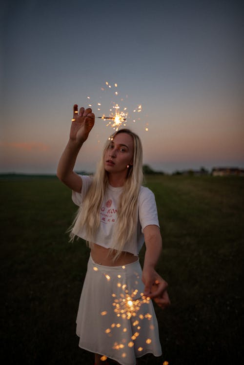 Free Girl in White T-shirt Holding Sparklers Stock Photo
