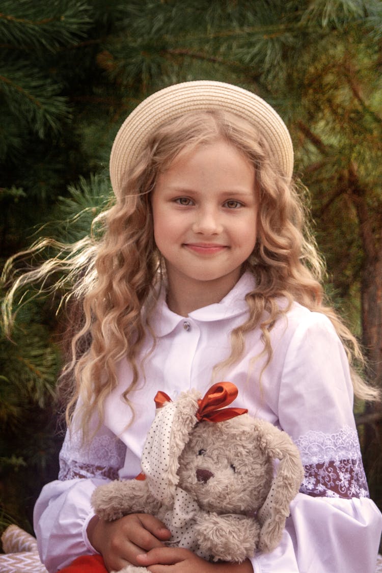 Girl With Straw Hat Holding Teddy Bear 