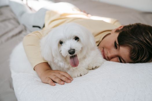 A Kid Lying Down with His Dog