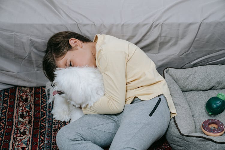 A Boy Hugging His Pet Dog