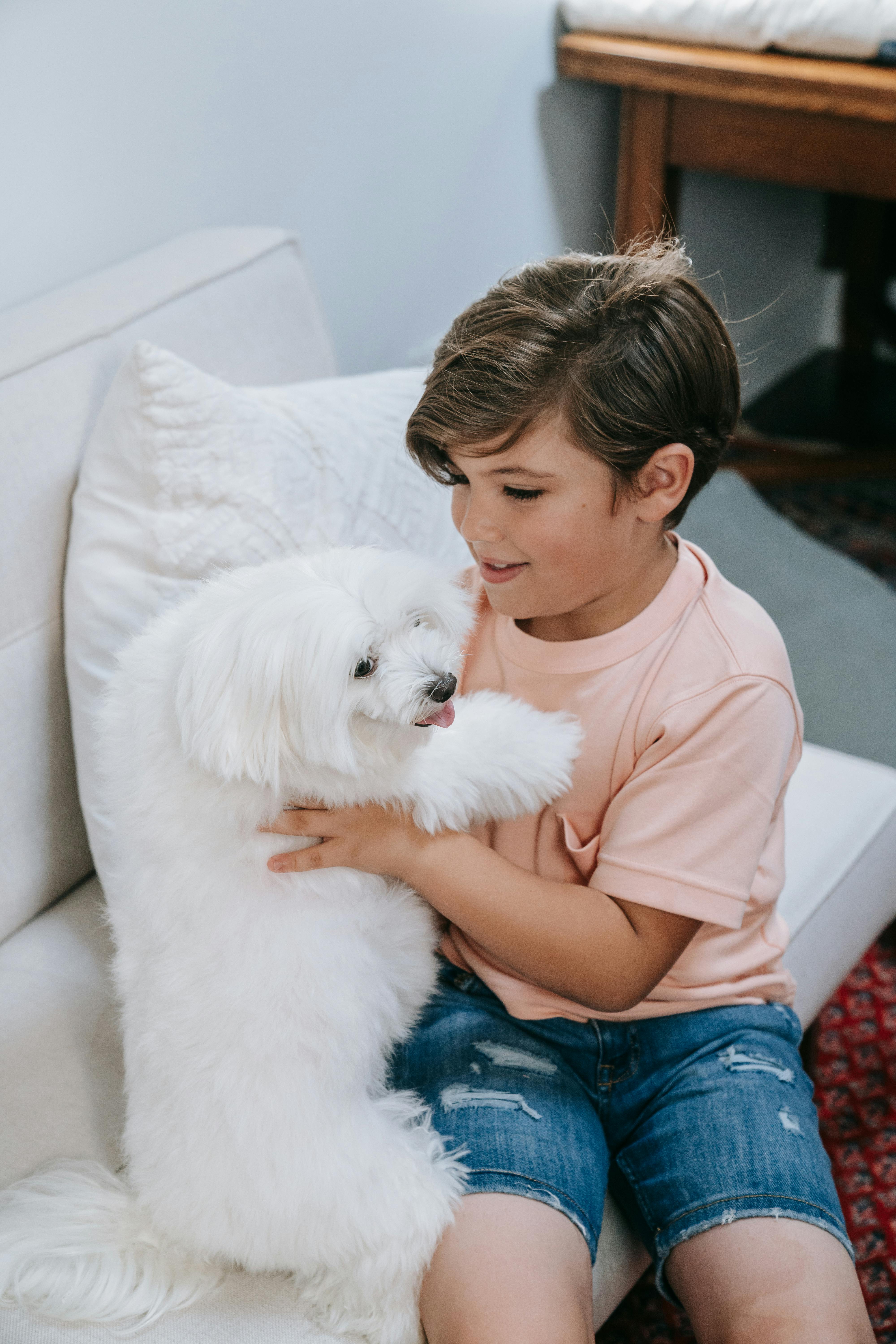 A Boy Picking Up His Dog