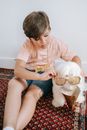 Woman in Beige Crew Neck T-shirt and Blue Denim Shorts Sitting on Red and White