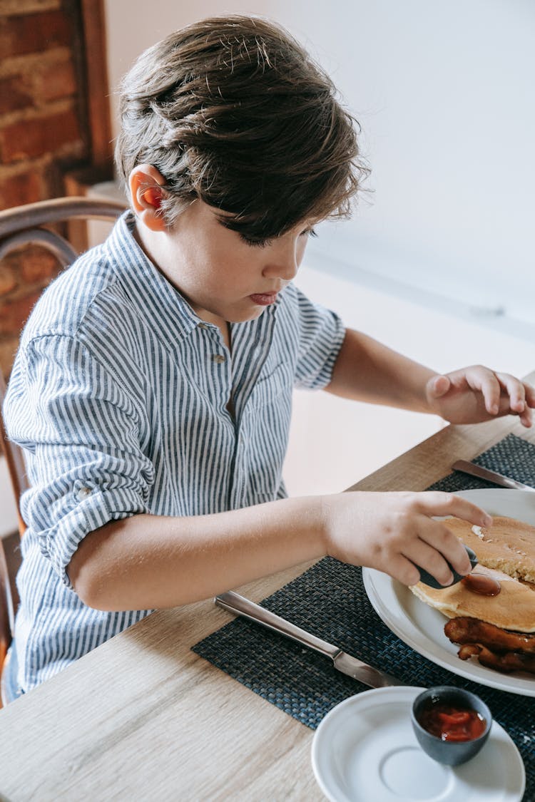 A Boy Eating Pancakes