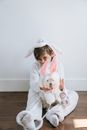 Woman in White Long Sleeve Shirt Holding White Dog
