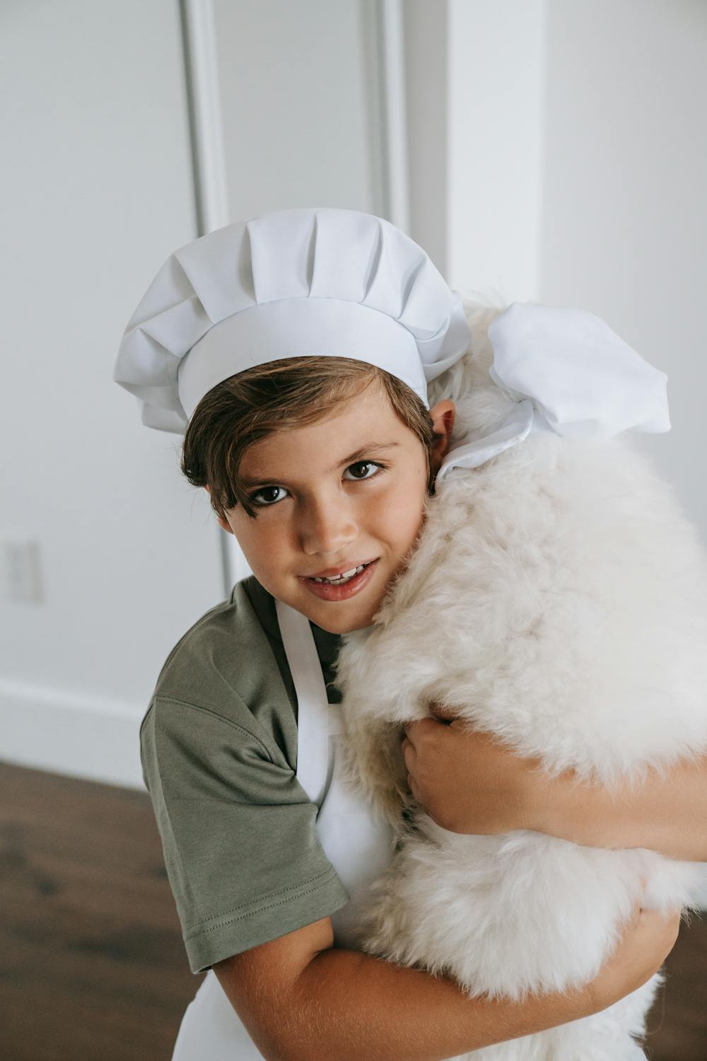 A Boy Wearing a Toque Carrying His Dog · Free Stock Photo