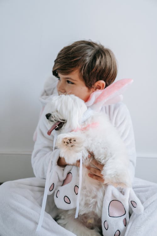 Free Photo of a Boy Holding His Dog Stock Photo