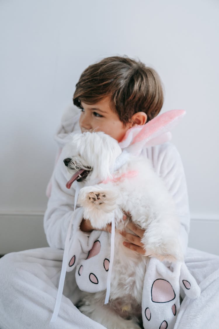 Photo Of A Boy Holding His Dog