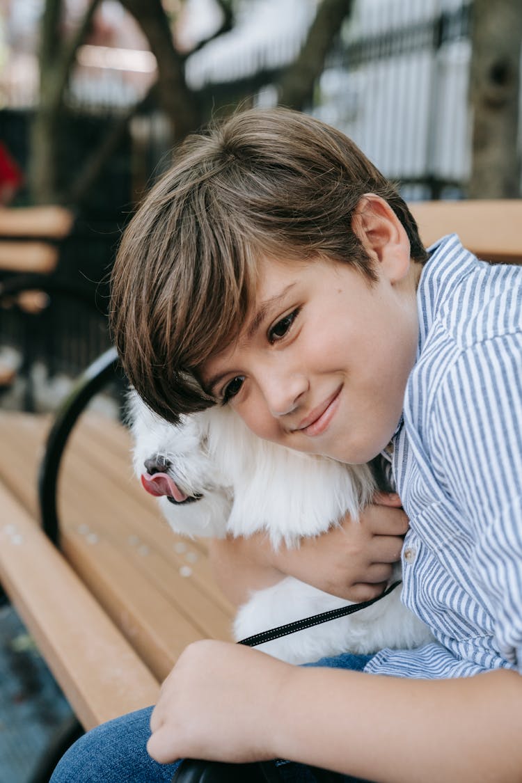 Boy Hugging White Furry Animal