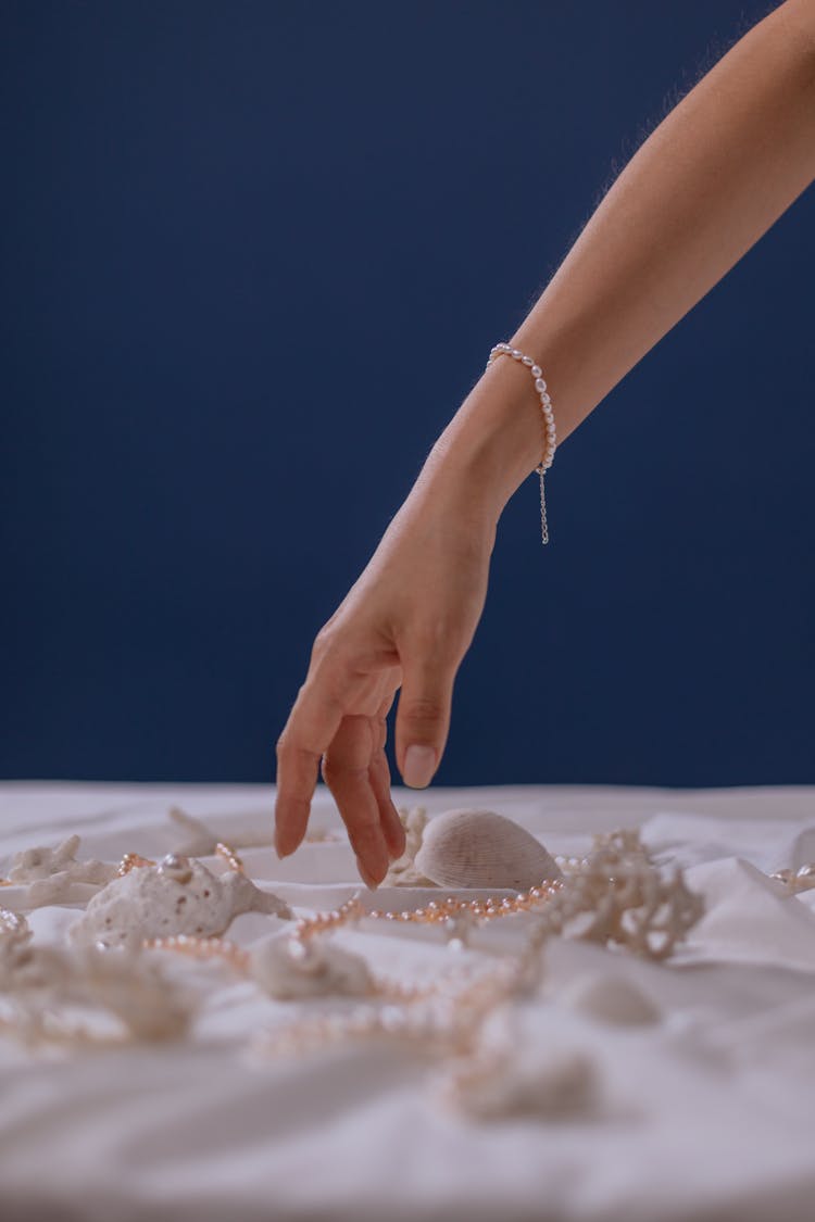 A Woman Wearing A Bracelet Reaching For A Jewelry