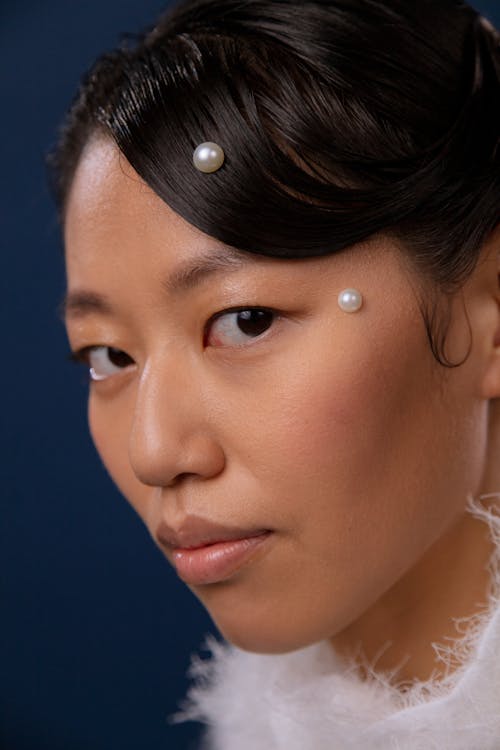 Free Portrait of a Woman with Pearls on Her Face Stock Photo