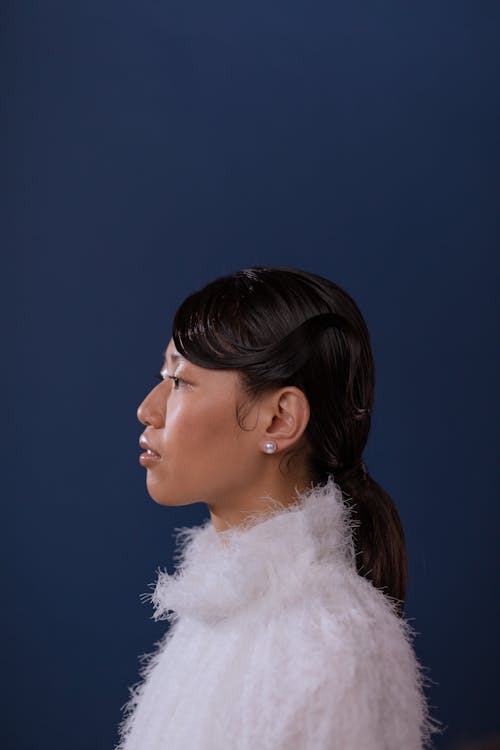 Side Profile of Woman in White Fur Coat
