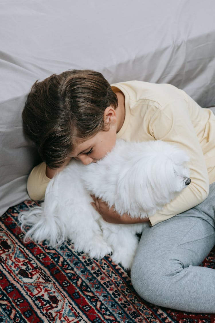 A Boy Hugging His Pet Dog