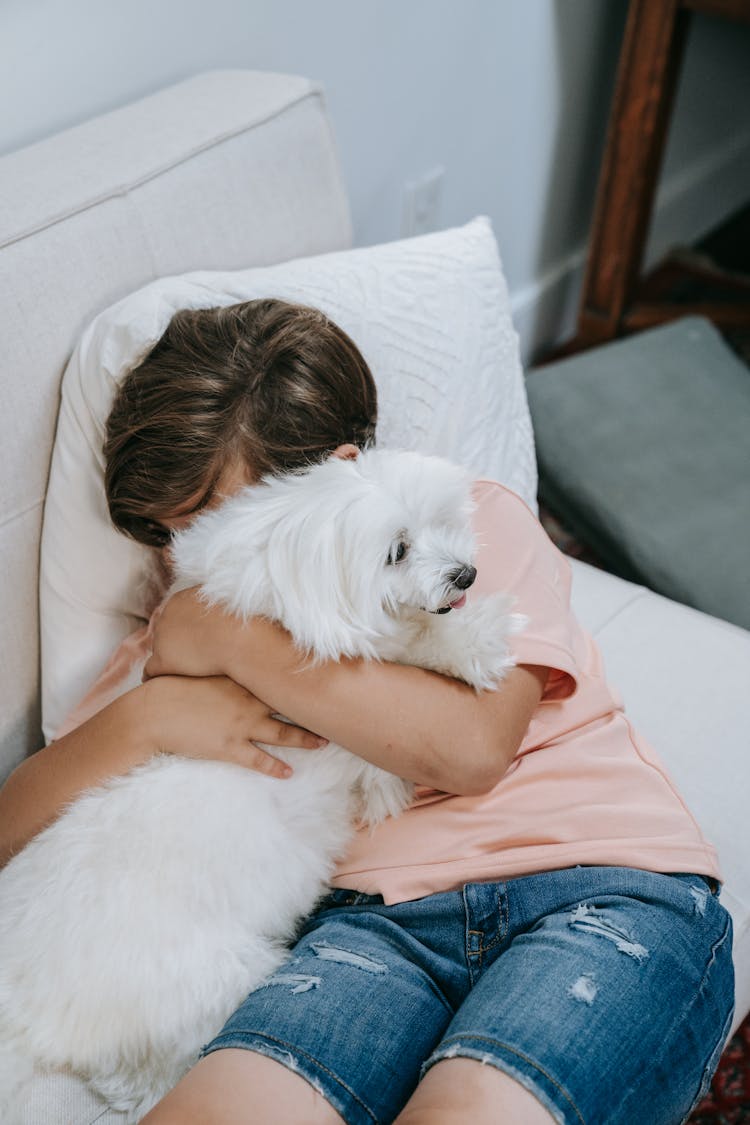 A Boy Hugging His Pet Dog