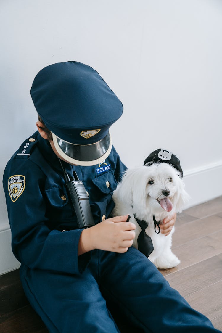 Boy Wearing A Police Costume With His Dog