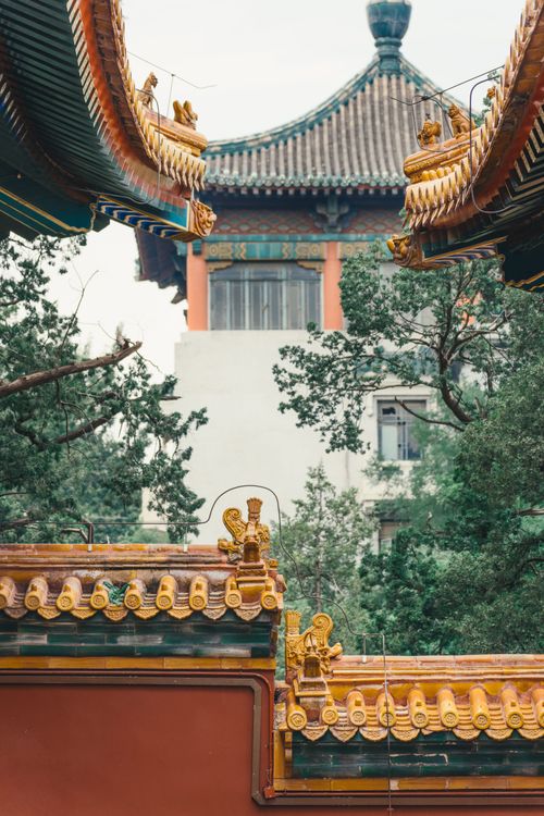Free Discover the intricate details of traditional Chinese architecture in a Beijing park, surrounded by lush greenery. Stock Photo