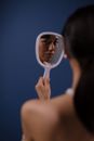 Woman in Black Tank Top Holding Magnifying Glass