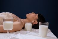 Woman in White Tank Top Lying on Bed