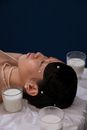 Woman in White Pearl Necklace Lying on Bed