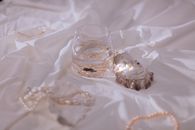 Clear Glass Cup on White Textile