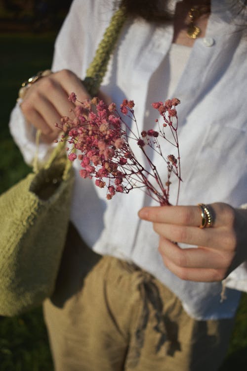 A Woman Holding Small Flowers